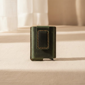 Green leather money clip card holder wallet on a neutral background