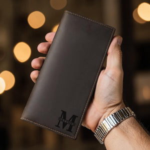 Man holding custom engraved leather long wallet, lifestyle photo