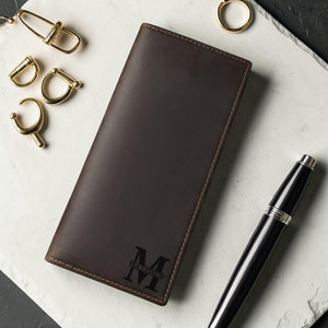 Monogrammed leather long wallet flat lay with luxury accessories