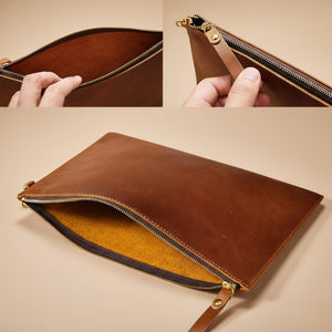 Brown leather clutch with zipper closure