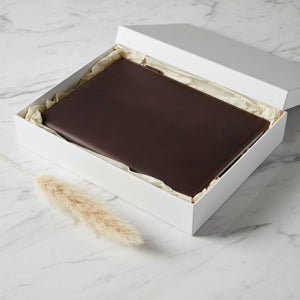 Coffee brown leather journal cover in a white gift box on marble