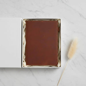 Brown leather journal cover with a bookmark presented in a gift box